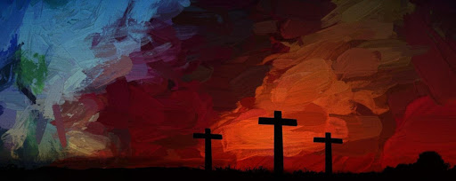 Silhouetted crosses are stark against a dark red cloudy sunset sky.